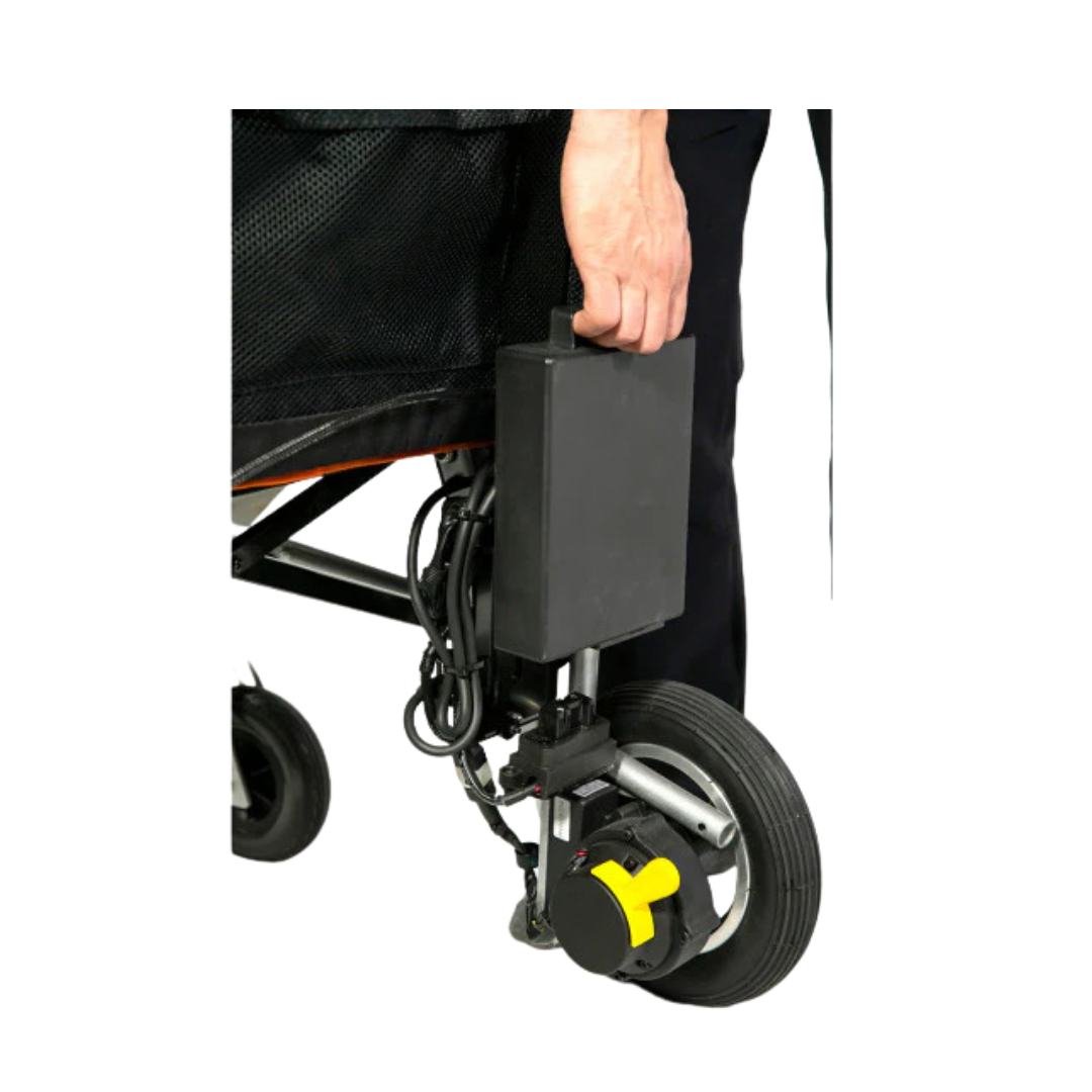 A person’s hand grips the Feather Battery Replacement For Feather Powerchair, a rectangular 24V 8Ah lithium battery attached near the wheel of a mobility aid, with a visible yellow wheel locking mechanism below.